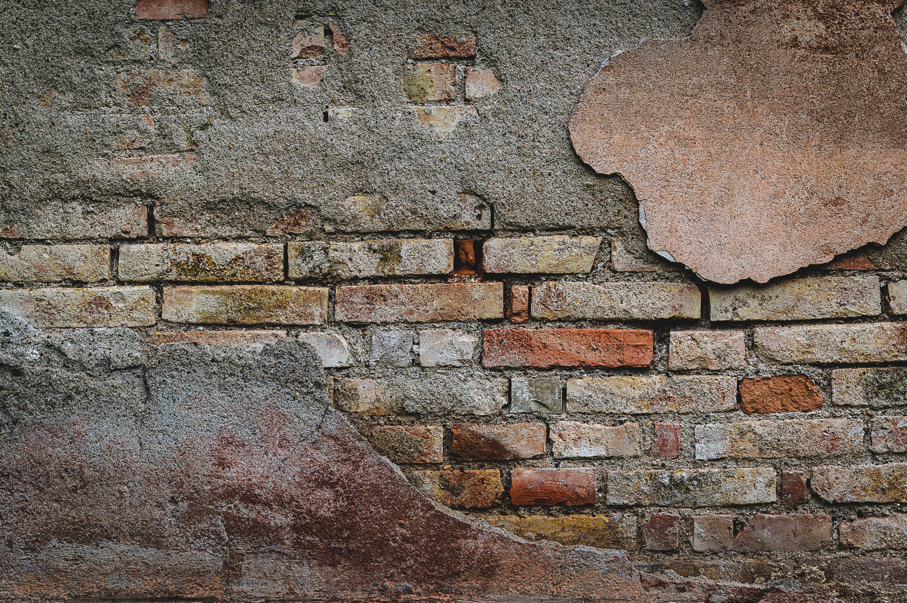 A wall crack with a ruler held against it to show its width for assessment